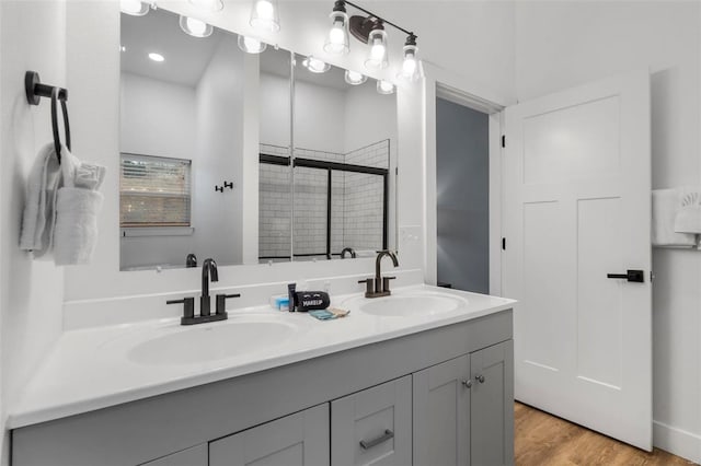 bathroom featuring vanity, hardwood / wood-style flooring, and walk in shower