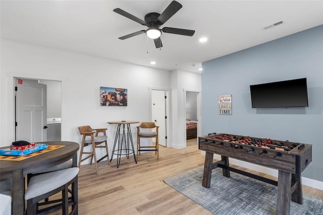 rec room with ceiling fan and light wood-type flooring