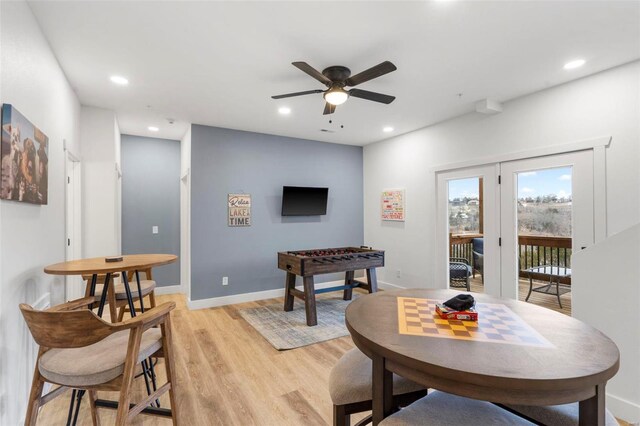 dining area with ceiling fan and light wood-type flooring