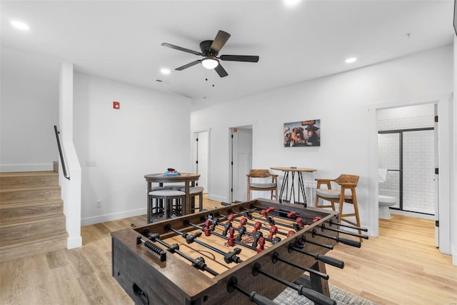 rec room featuring light hardwood / wood-style flooring and ceiling fan