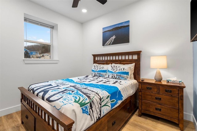 bedroom with light hardwood / wood-style floors and ceiling fan