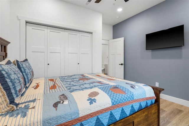 bedroom with a closet, light hardwood / wood-style flooring, and ceiling fan