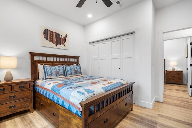 bedroom with ceiling fan, a closet, and light hardwood / wood-style flooring