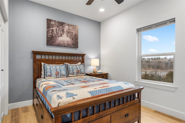 bedroom with light wood-type flooring and ceiling fan