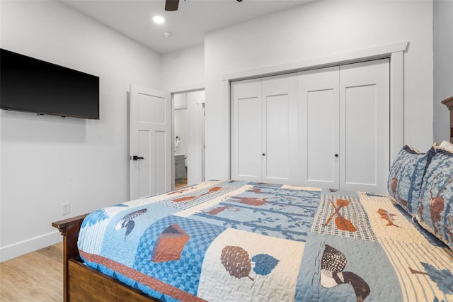 bedroom with ceiling fan, a closet, and light hardwood / wood-style floors