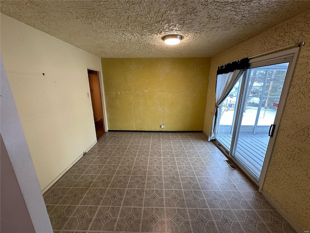 spare room featuring a textured ceiling