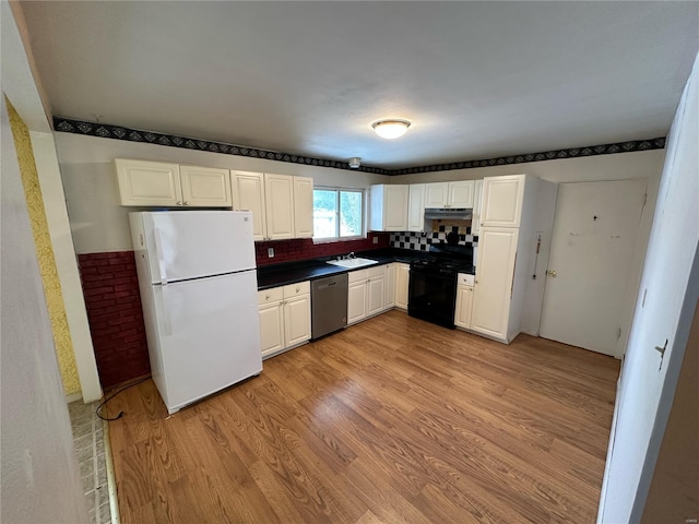 kitchen with black gas stove, sink, stainless steel dishwasher, light wood-type flooring, and white fridge