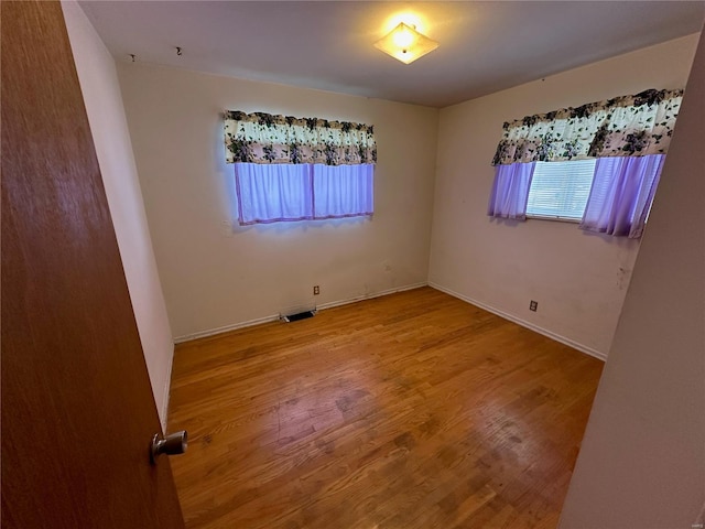 empty room with wood-type flooring