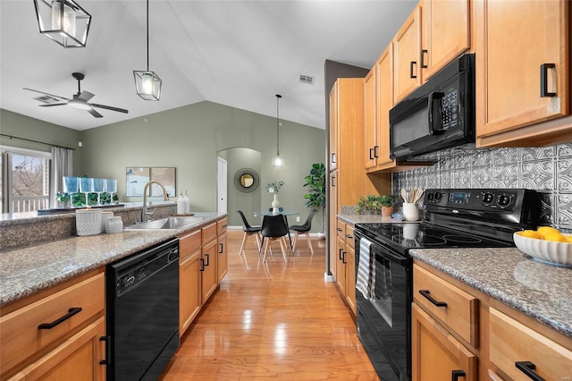 kitchen featuring sink, decorative light fixtures, ceiling fan, and black appliances