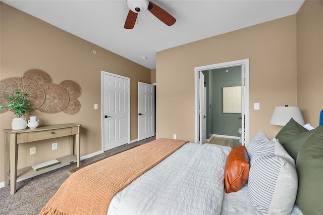 bedroom featuring ensuite bathroom, ceiling fan, and light carpet