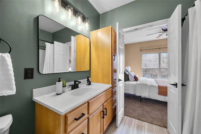 bathroom with ceiling fan, vanity, and hardwood / wood-style flooring