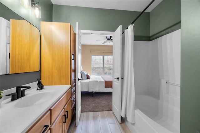 bathroom featuring shower / bath combo with shower curtain, hardwood / wood-style floors, and vanity