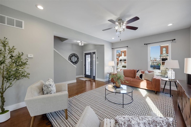 living room with ceiling fan and dark hardwood / wood-style floors