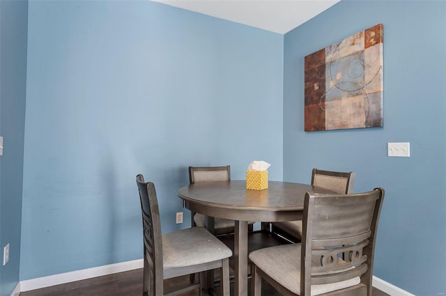 dining space featuring dark hardwood / wood-style floors