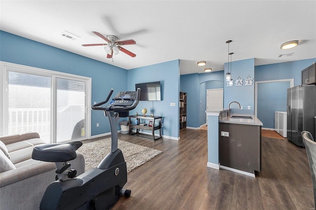 workout room with dark hardwood / wood-style floors, ceiling fan, and sink