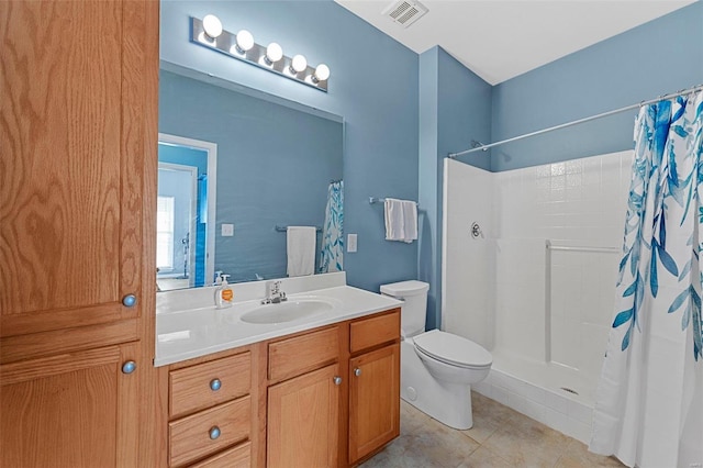 bathroom featuring toilet, a shower with curtain, vanity, and tile patterned floors