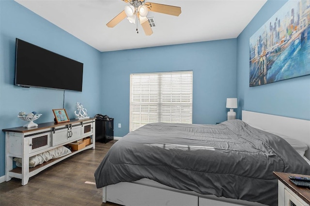 bedroom with ceiling fan and dark hardwood / wood-style flooring