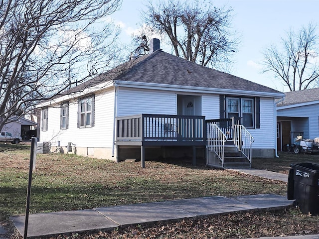 view of front facade featuring a deck and a front lawn