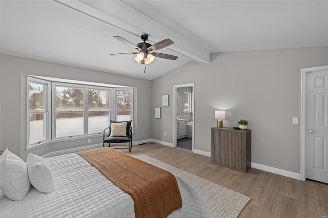 bedroom featuring vaulted ceiling with beams, light hardwood / wood-style floors, ceiling fan, and ensuite bathroom