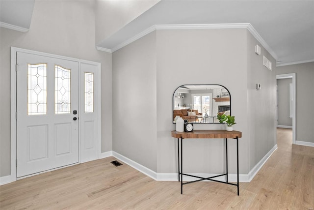 entrance foyer featuring light hardwood / wood-style floors and ornamental molding