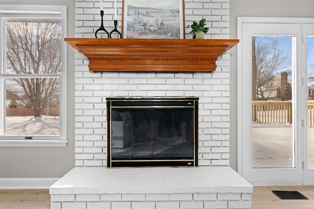 room details featuring hardwood / wood-style floors and a brick fireplace