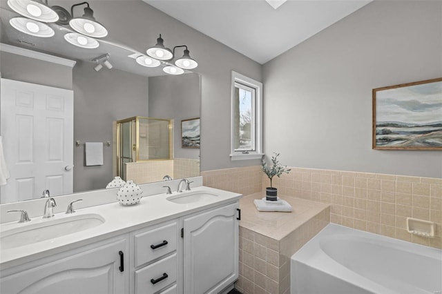 bathroom featuring vanity and shower with separate bathtub