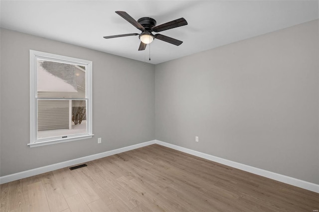 empty room featuring ceiling fan and light wood-type flooring