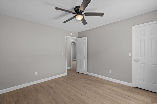 unfurnished bedroom with ceiling fan and light wood-type flooring