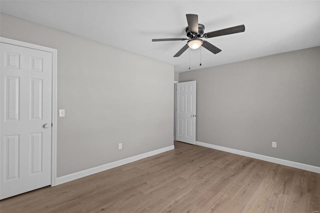 spare room featuring light hardwood / wood-style flooring and ceiling fan