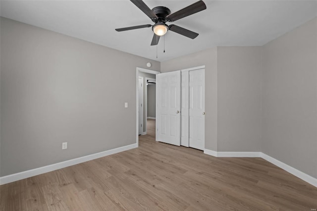 unfurnished bedroom featuring ceiling fan, a closet, and light hardwood / wood-style flooring