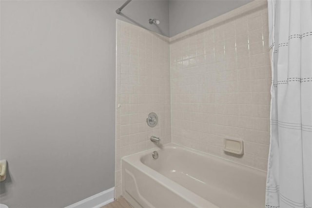 bathroom with shower / bath combo with shower curtain