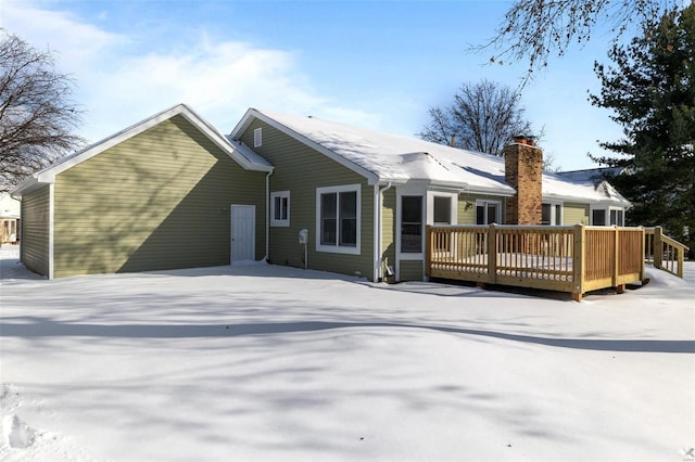 rear view of property featuring a deck