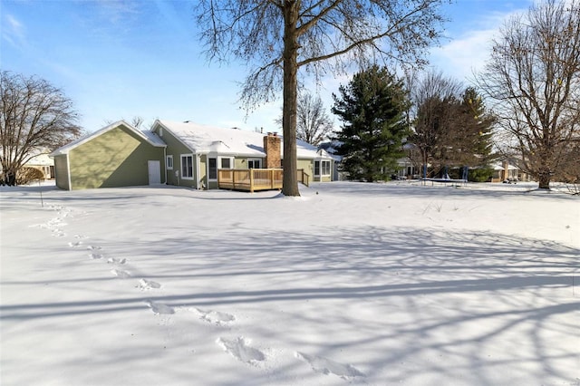 yard layered in snow featuring a deck