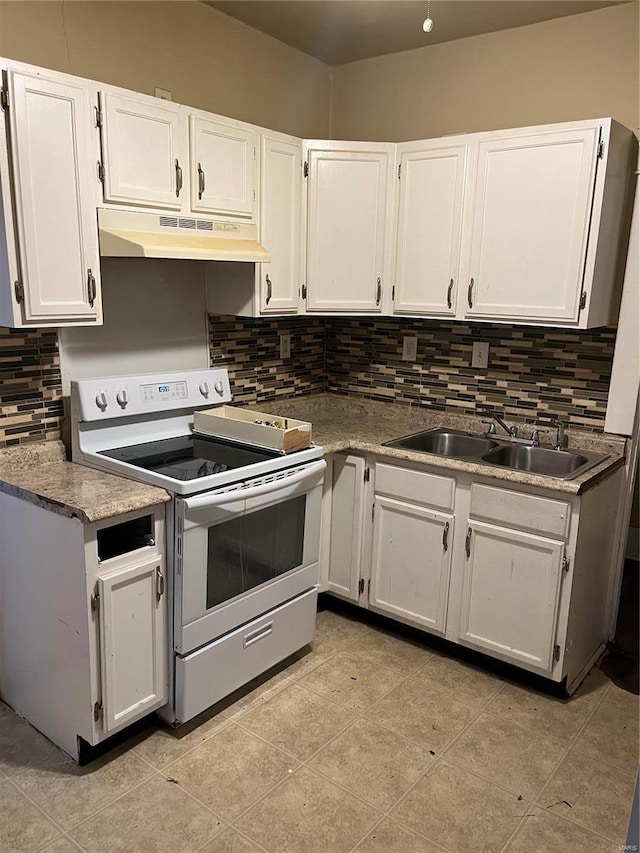 kitchen featuring backsplash, electric stove, sink, light tile patterned floors, and white cabinetry