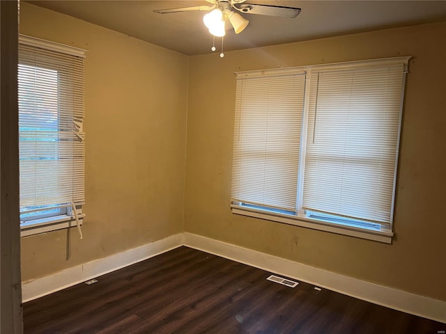 unfurnished room featuring ceiling fan and dark wood-type flooring