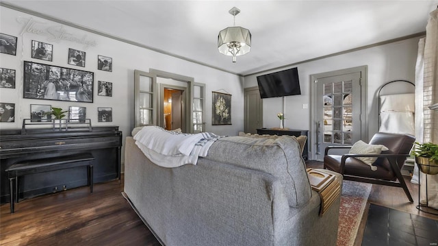 living room featuring ornamental molding and dark wood-type flooring