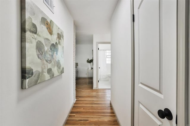 hallway with hardwood / wood-style floors