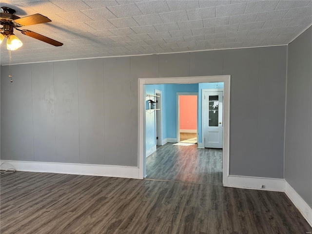 empty room featuring ceiling fan and dark hardwood / wood-style flooring