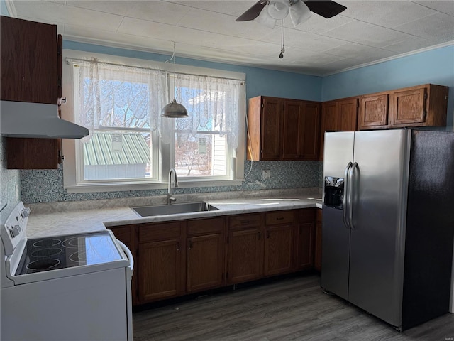 kitchen featuring stainless steel refrigerator with ice dispenser, white electric range oven, sink, wood-type flooring, and decorative light fixtures