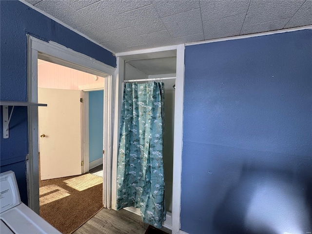 bathroom featuring hardwood / wood-style floors and washer / clothes dryer