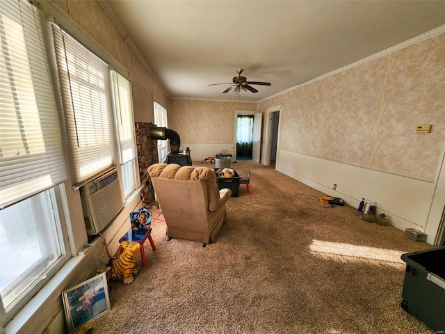 carpeted living room with ceiling fan, plenty of natural light, and ornamental molding