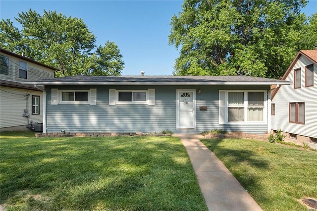 view of front of home with a front lawn and central air condition unit