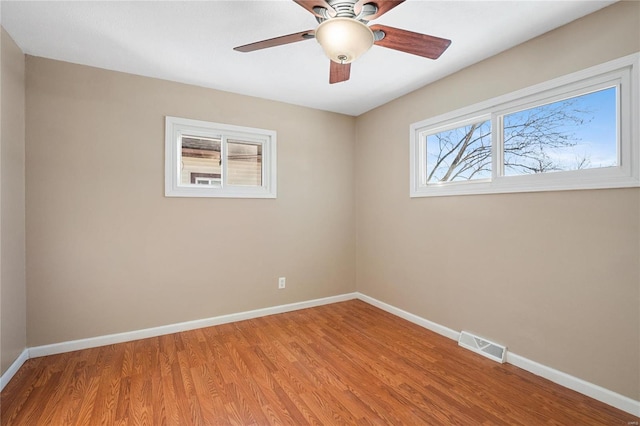 spare room featuring hardwood / wood-style flooring and ceiling fan