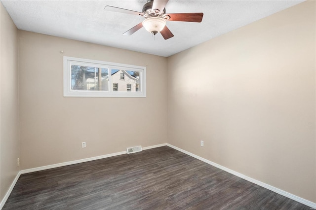 empty room featuring ceiling fan, dark hardwood / wood-style floors, and a textured ceiling