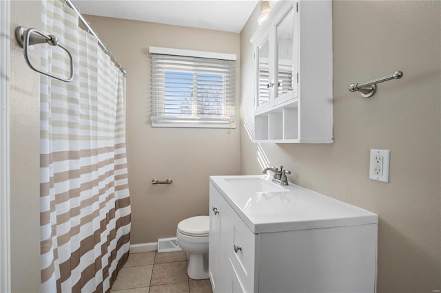 bathroom featuring tile patterned floors, toilet, and vanity