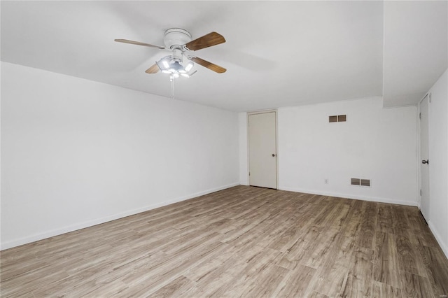 spare room with light hardwood / wood-style flooring and ceiling fan