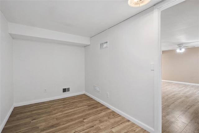 spare room featuring hardwood / wood-style flooring and ceiling fan