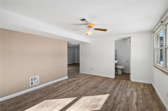 unfurnished bedroom with wood-type flooring, ceiling fan, and ensuite bathroom