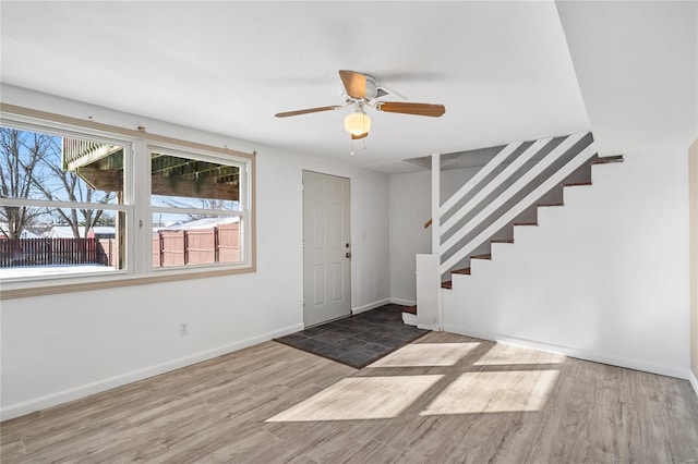 foyer with ceiling fan and wood-type flooring