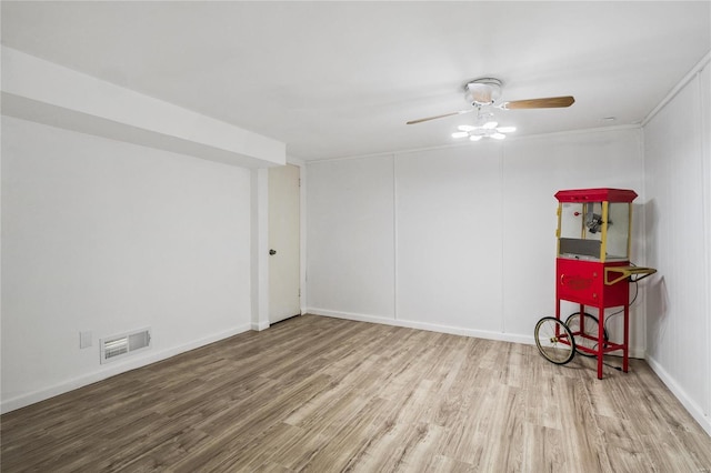 spare room featuring ceiling fan and hardwood / wood-style floors